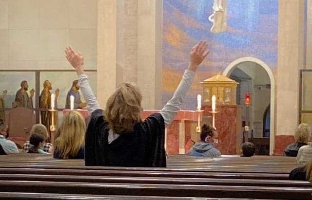 Marybeth Wuenschel praising God at a Catholic charismatic worship service